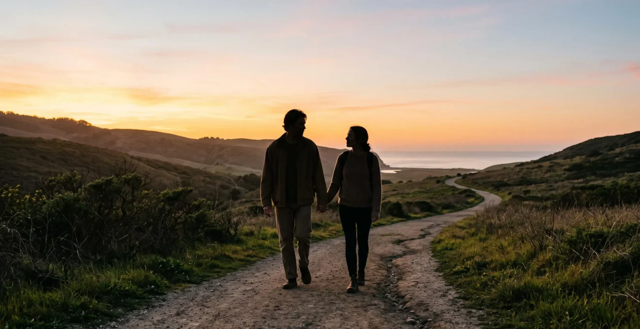 Un couple marchant côte à côte sur un chemin qui passe d'une lumière chaude de coucher de soleil à une lumière douce et stable, symbolisant le passage de l'attirance à une relation durable.